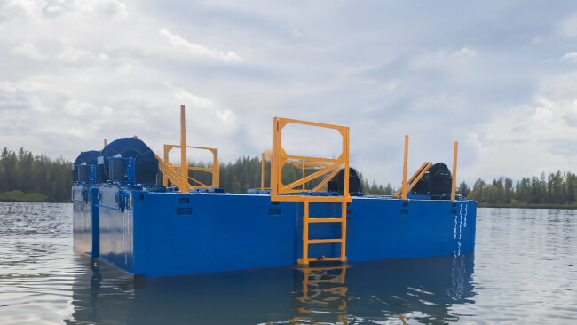 Blue industrial barge floating on a calm river